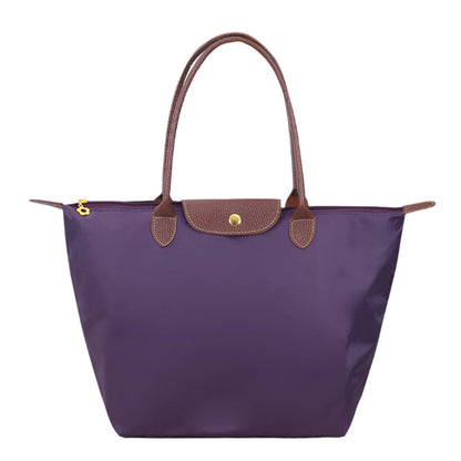 Women’s shoulder bag with compact silhouette and functional compartments