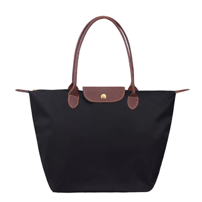 Women’s shoulder bag with compact silhouette and functional compartments