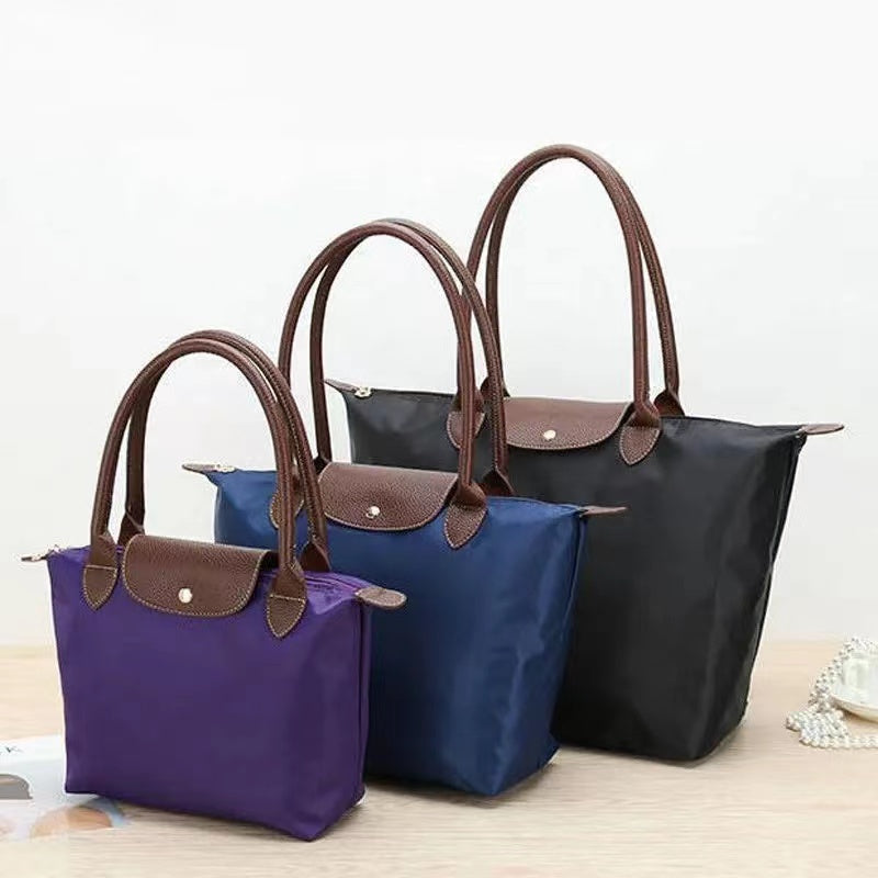 Women’s shoulder bag with compact silhouette and functional compartments
